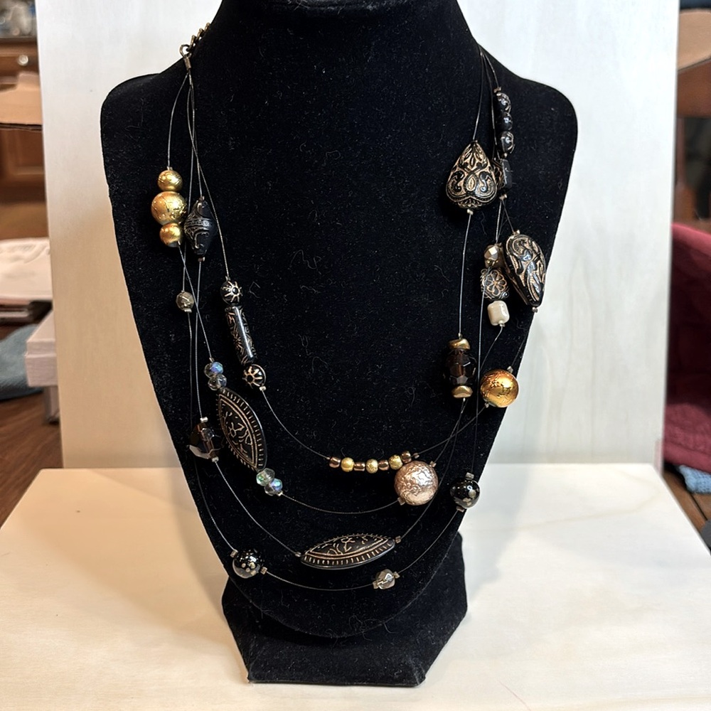 Chicos four strand necklace beads on thin wire. Glass and acrylic beads.